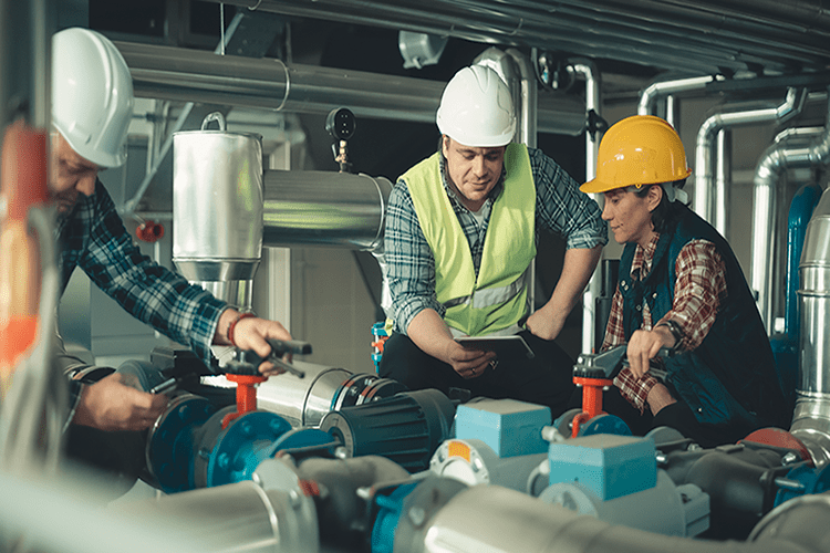 HVAC workers work on a commercial system. Commercial HVAC: What to Know About Heating and Cooling Your Business.