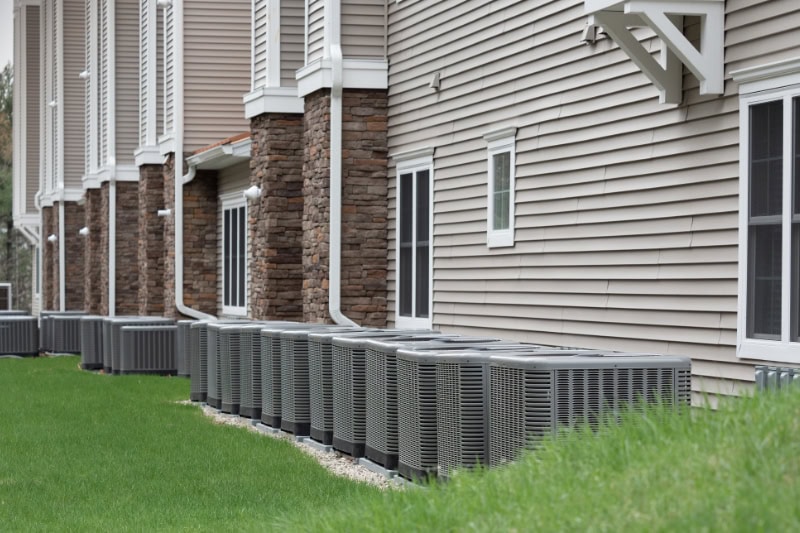 Modern air conditioning and heating units or heat pumps, used in homes and apartments without central air conditioning.