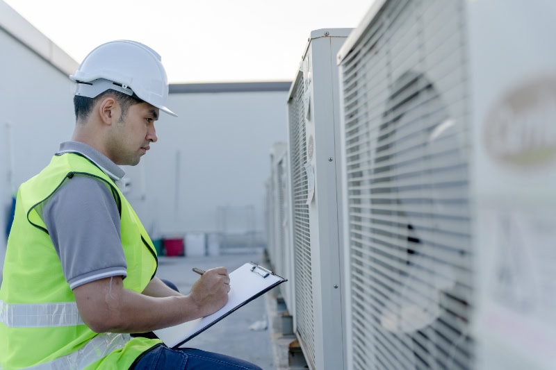 3 Commercial HVAC Systems to Know About. Contractor inspects compressor system and plans installation of air condition systems in construction site of modern buildings.