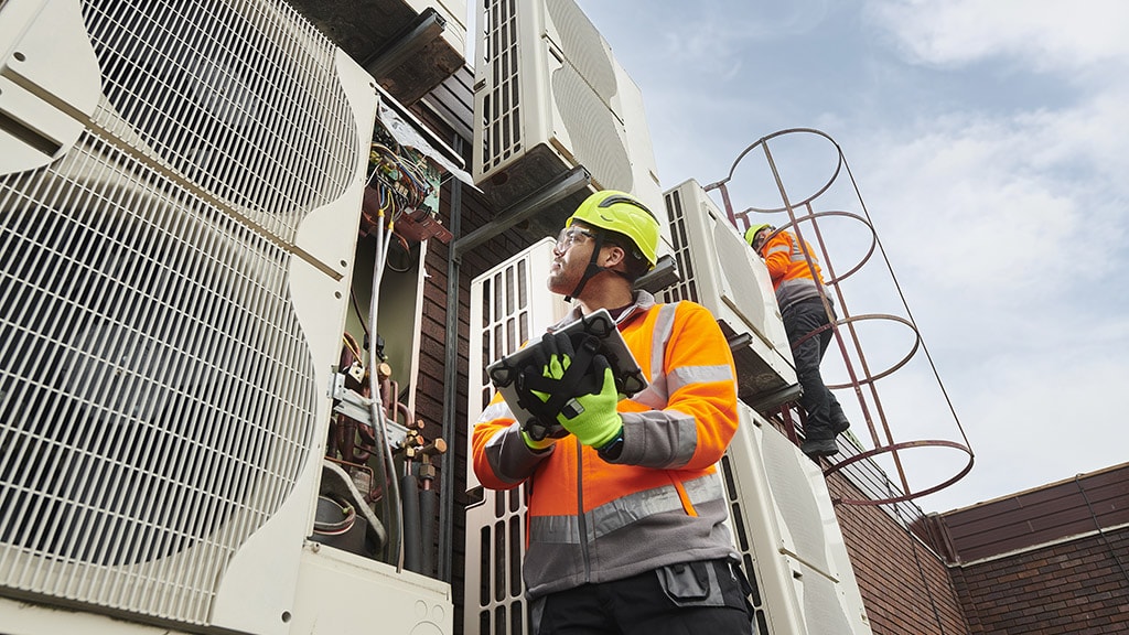 HVAC engineers servicing a commercial air conditioning system.